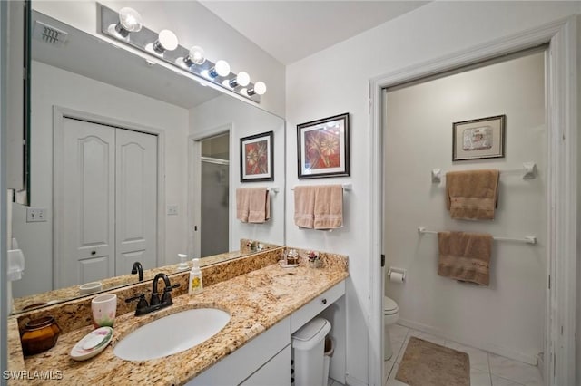 bathroom featuring walk in shower, tile patterned floors, vanity, and toilet