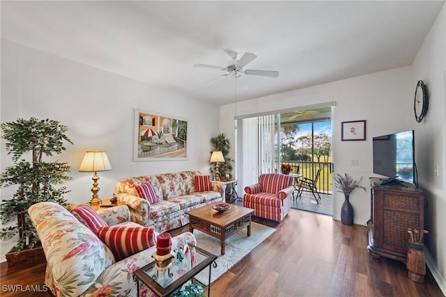 living room featuring dark hardwood / wood-style floors and ceiling fan