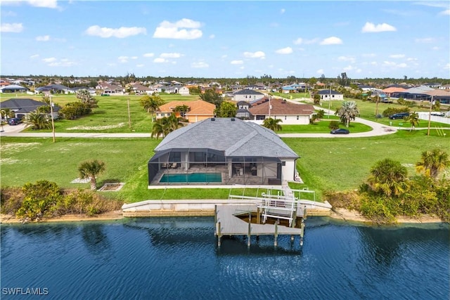 birds eye view of property with a water view and a residential view