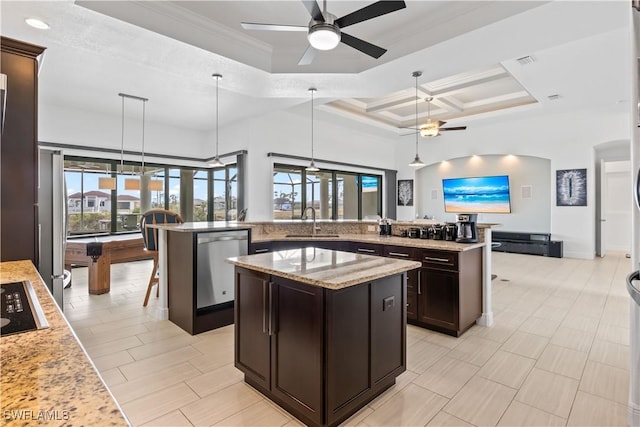 kitchen with pendant lighting, stainless steel dishwasher, and a kitchen island