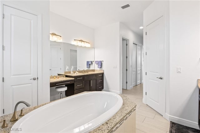 bathroom with vanity and a bathtub