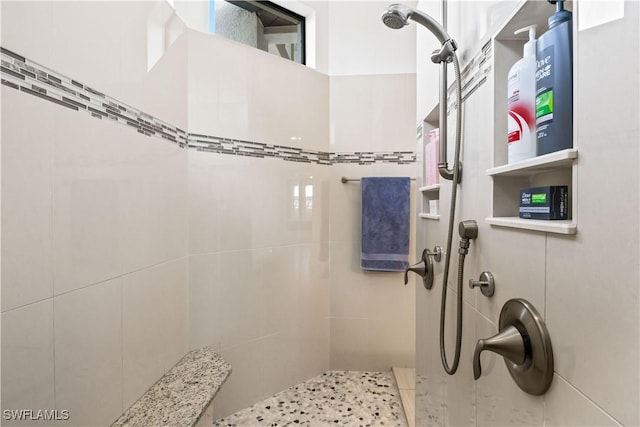 bathroom with a tile shower