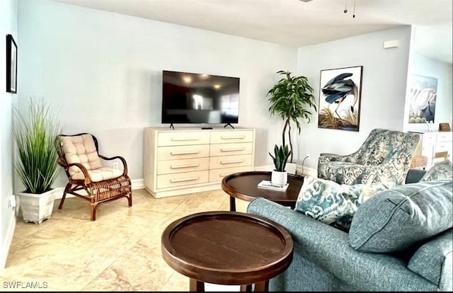 living area featuring light tile patterned flooring and ceiling fan