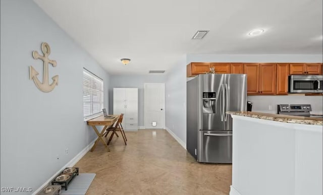 kitchen featuring light stone countertops and appliances with stainless steel finishes