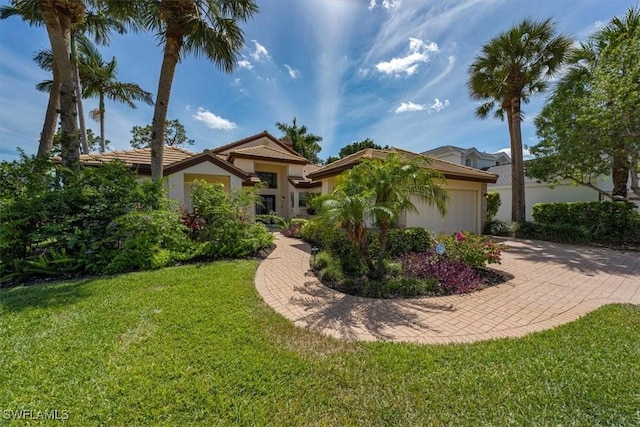 view of front of house with a front yard and a garage