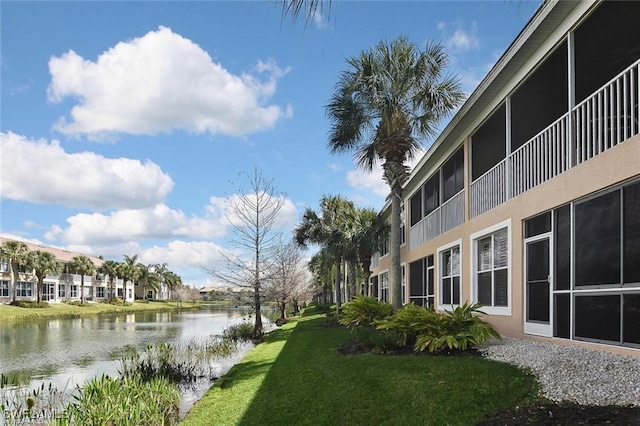 exterior space with a lawn and a water view