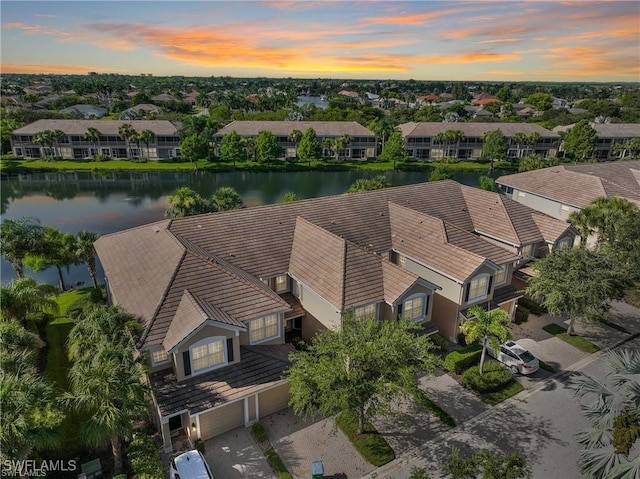 aerial view at dusk with a water view