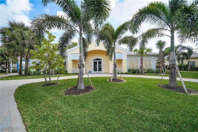 view of front of house with a front yard and french doors