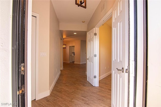 corridor with light hardwood / wood-style flooring