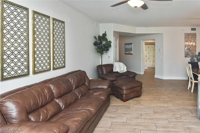 living room featuring ceiling fan and light wood-type flooring