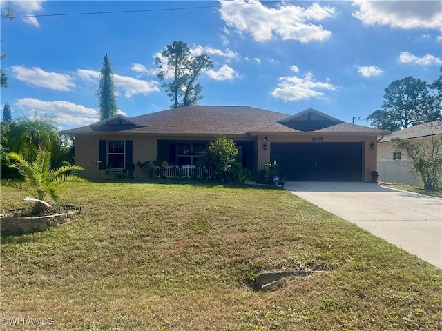 single story home featuring a garage and a front lawn