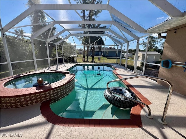 view of swimming pool with a lanai, a patio area, and a shed