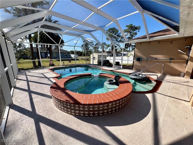 view of swimming pool featuring an in ground hot tub, a patio, a shed, and a lanai