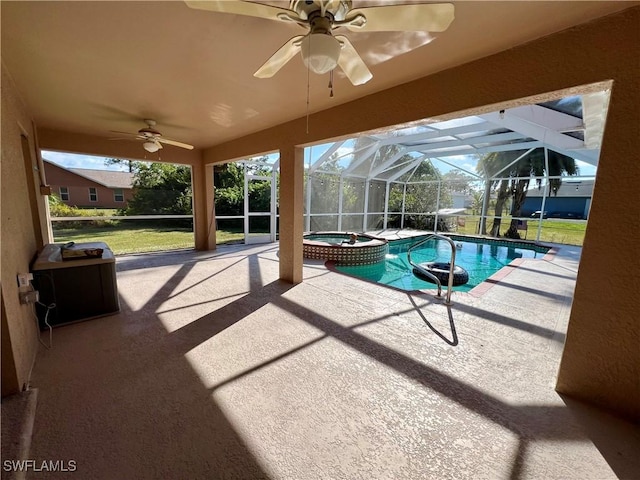 view of pool with glass enclosure, an in ground hot tub, a patio, ceiling fan, and a yard