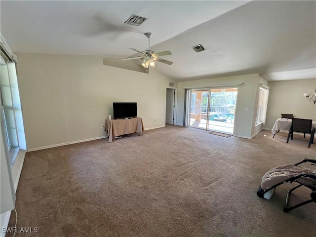 unfurnished living room with ceiling fan with notable chandelier, carpet flooring, and lofted ceiling