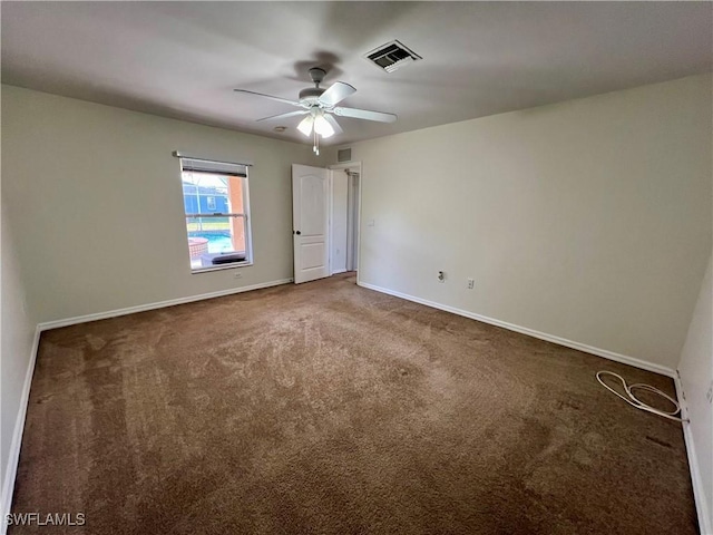 unfurnished bedroom featuring dark carpet and ceiling fan