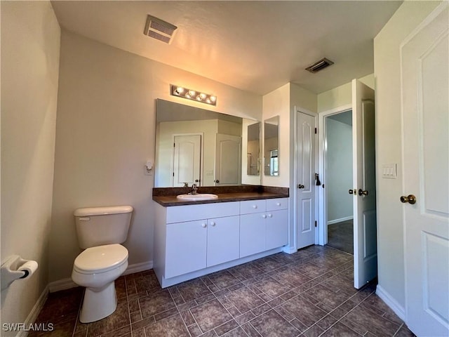 bathroom featuring toilet and vanity