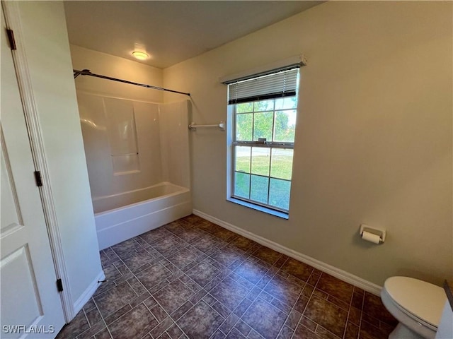 bathroom with toilet and  shower combination