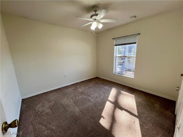 carpeted spare room with ceiling fan