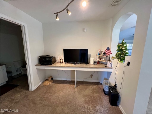 home office with carpet and built in desk