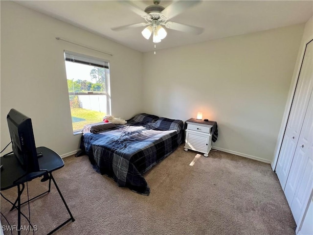 carpeted bedroom with a closet and ceiling fan