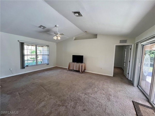 unfurnished living room featuring ceiling fan, dark carpet, and vaulted ceiling