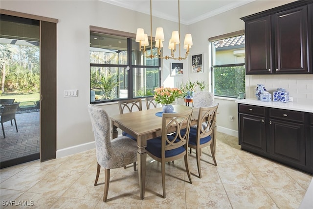 tiled dining area featuring an inviting chandelier and ornamental molding