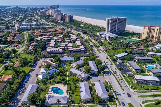 aerial view with a water view and a beach view