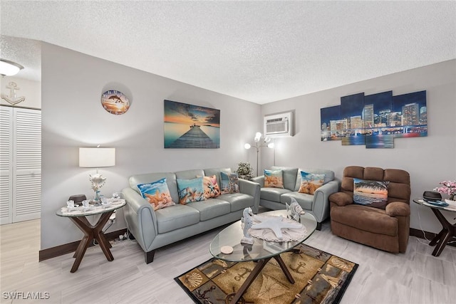 living room with a wall unit AC and a textured ceiling