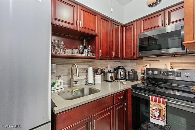 kitchen featuring tasteful backsplash, sink, and stainless steel appliances