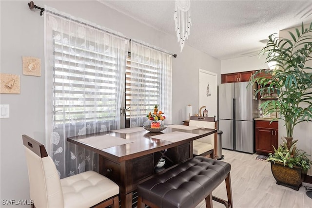 dining space with a textured ceiling