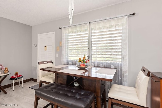 dining space featuring a textured ceiling