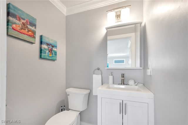 bathroom featuring crown molding, vanity, and toilet