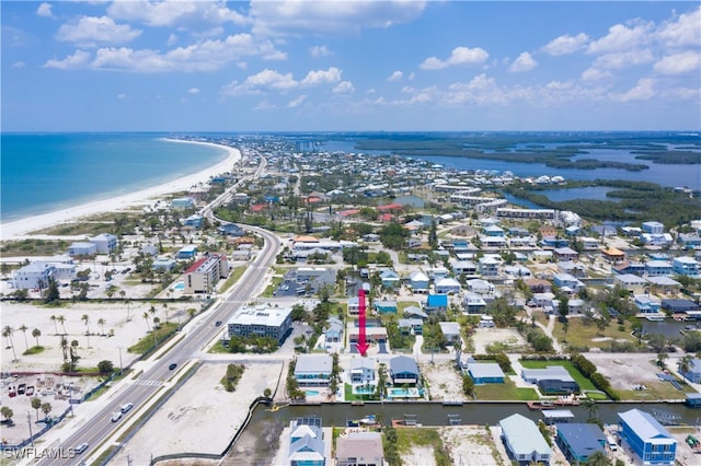 bird's eye view with a water view and a beach view