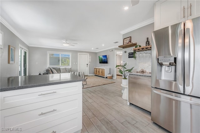 kitchen with stainless steel fridge with ice dispenser, light hardwood / wood-style flooring, ornamental molding, and white cabinets