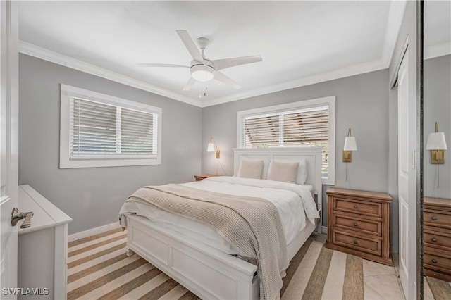 bedroom featuring ornamental molding, ceiling fan, and a closet