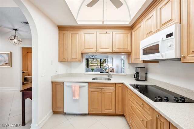 kitchen featuring sink, hanging light fixtures, light tile patterned floors, ceiling fan, and white appliances