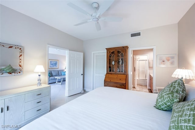 tiled bedroom with connected bathroom and ceiling fan