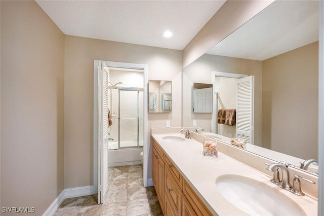 full bathroom featuring bath / shower combo with glass door, vanity, and toilet