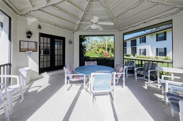 sunroom / solarium with lofted ceiling, french doors, and ceiling fan