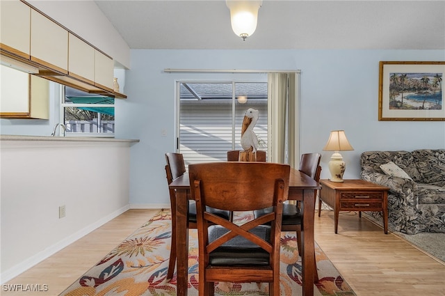 dining space with light hardwood / wood-style flooring