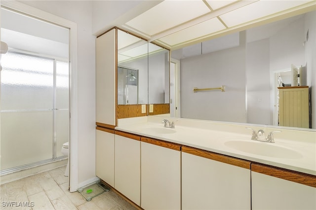 bathroom with vanity, an enclosed shower, and toilet