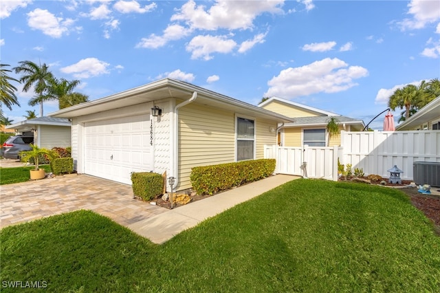 view of property exterior with a garage, a lawn, and central air condition unit