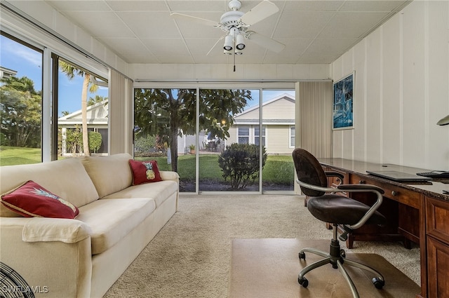 carpeted office space with a healthy amount of sunlight and ceiling fan