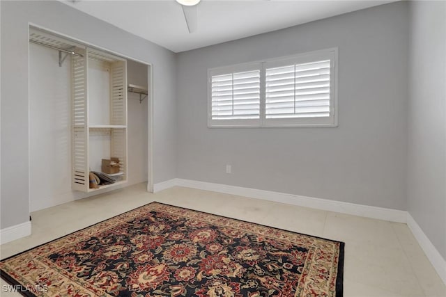 bedroom with tile patterned flooring, a closet, and ceiling fan