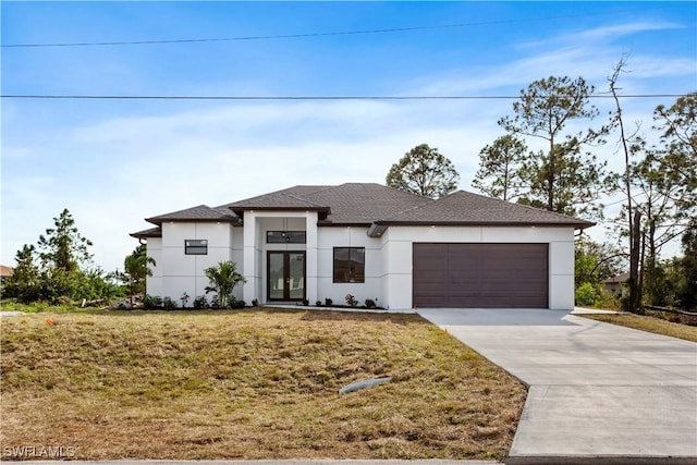 view of front of home with a garage and a front lawn