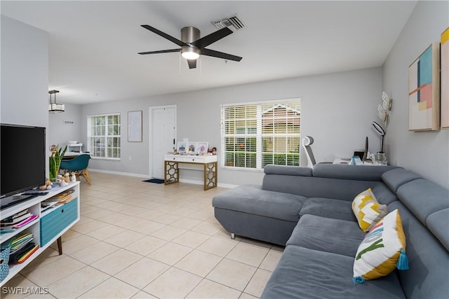 tiled living room featuring ceiling fan