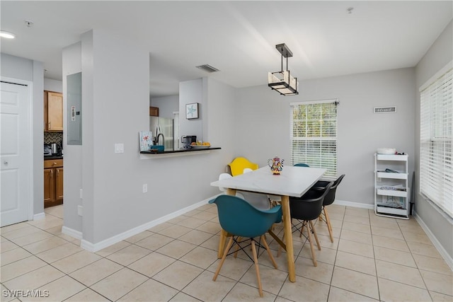 dining area with light tile patterned floors