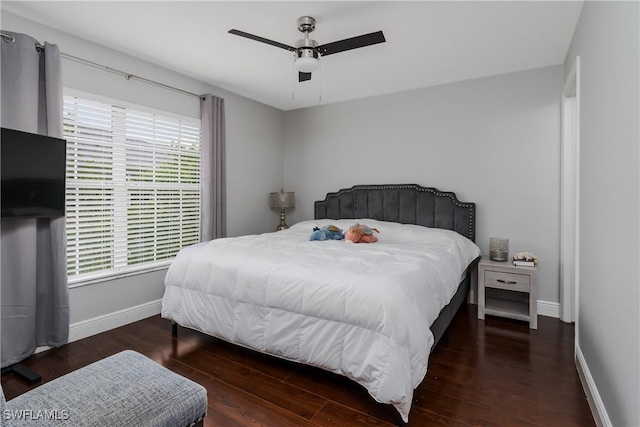 bedroom with dark hardwood / wood-style flooring and ceiling fan