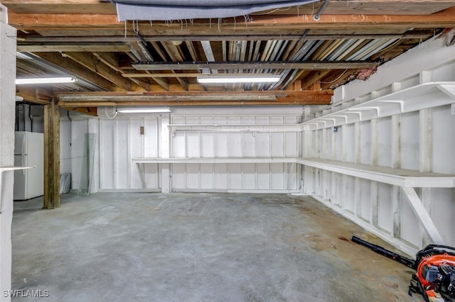 basement featuring white refrigerator